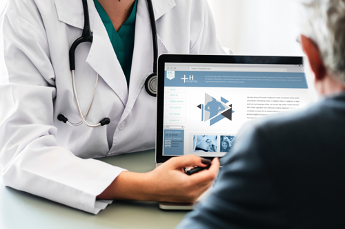 female healthcare worker explains PCP services to elderly male physician